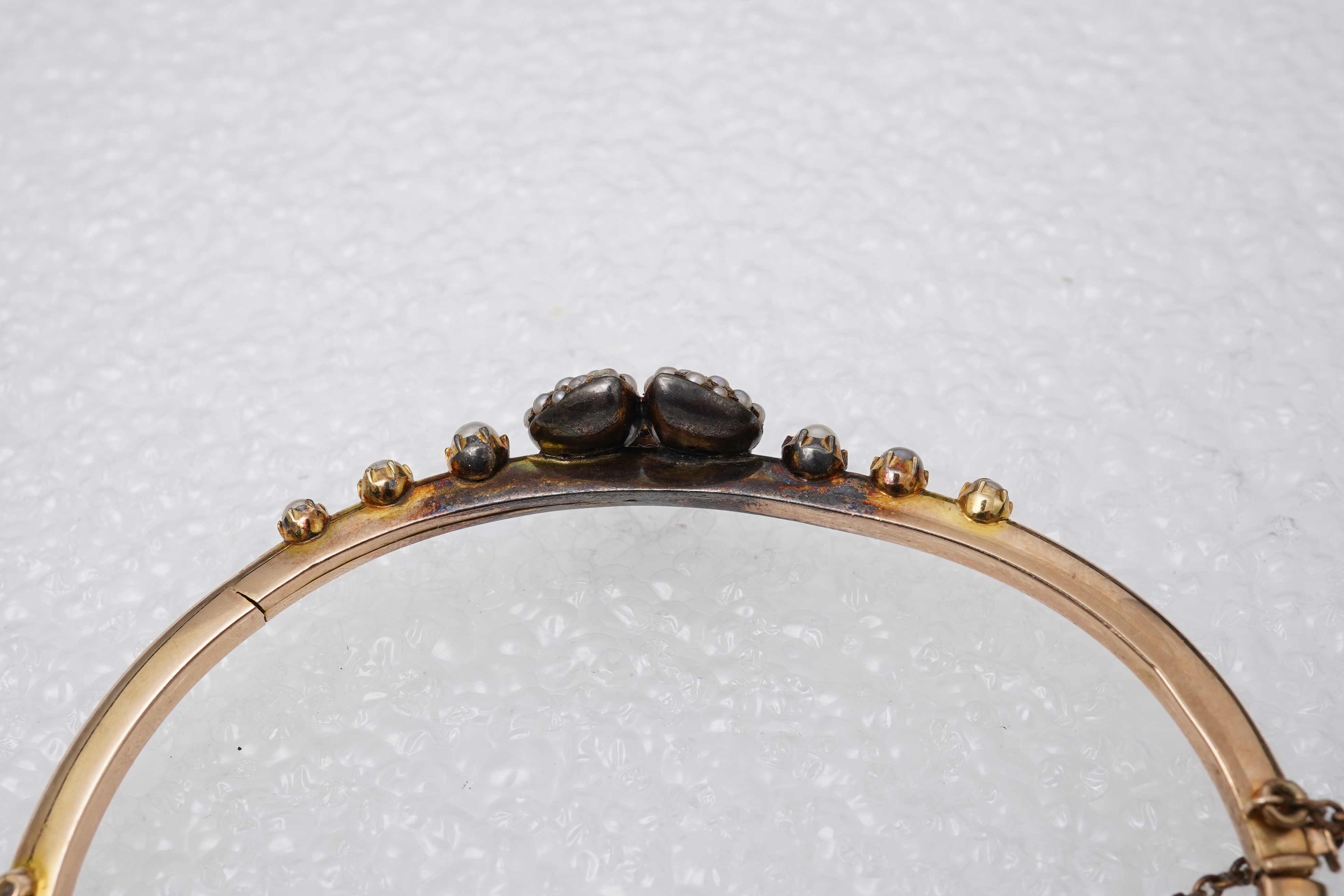 An Edwardian seed pearl and diamond bangle, early 20th century